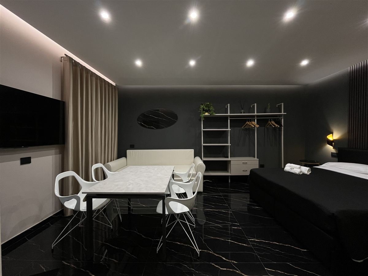Zona giorno con tavolo da pranzo e salotto, Élite Holiday Apartments
